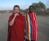 Me with one of  the Maasai warriors in the morning before we left. The stick I'm chewing on is their idea of a toothbrush. You can see their brush fence in the background.